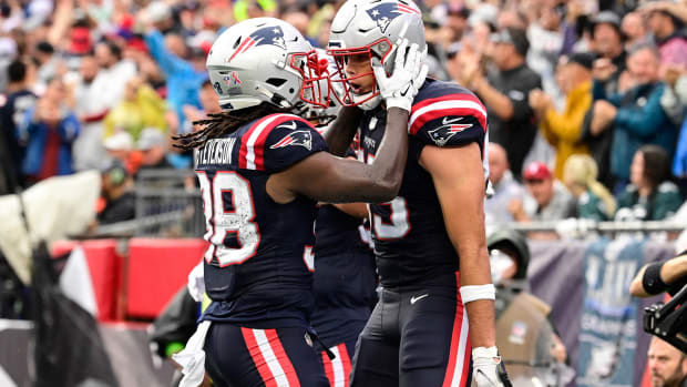 Sep 10, 2023; Foxborough, Massachusetts, USA; New England Patriots tight end Hunter Henry (right) celebrates a touchdown with running back Rhamondre Stevenson (38) during the first half against the Philadelphia Eagles at Gillette Stadium. Mandatory Credit: Eric Canha-USA TODAY Sports  